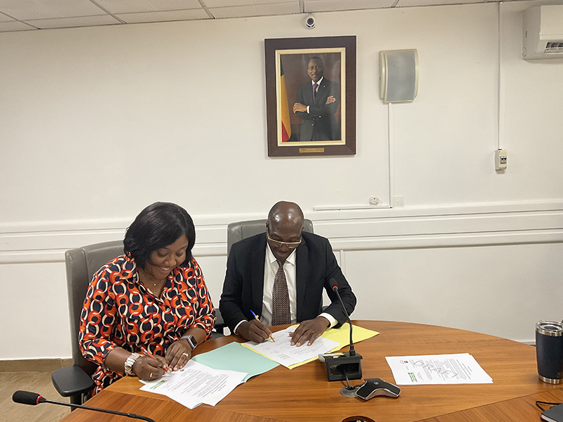 Two people signing documents.