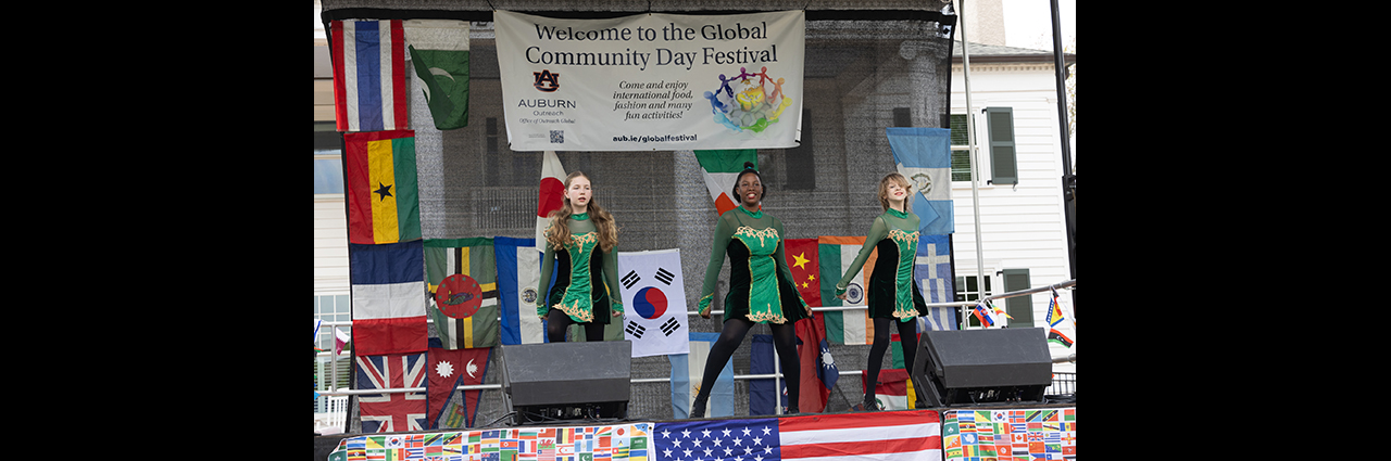 Three girls dancing on a stage.
