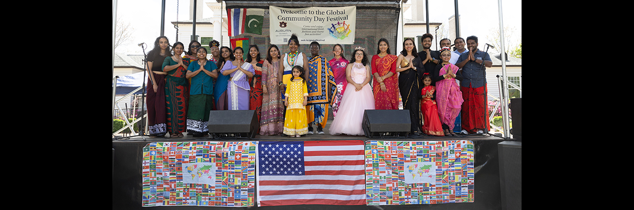 People on stage in cultural attire.